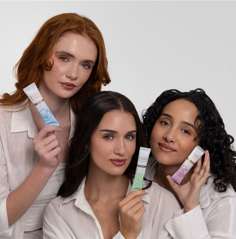 Three women holding Halo sachets