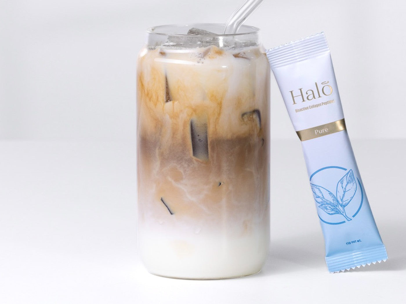 A Halo 100% Pure sachet beside an iced latte