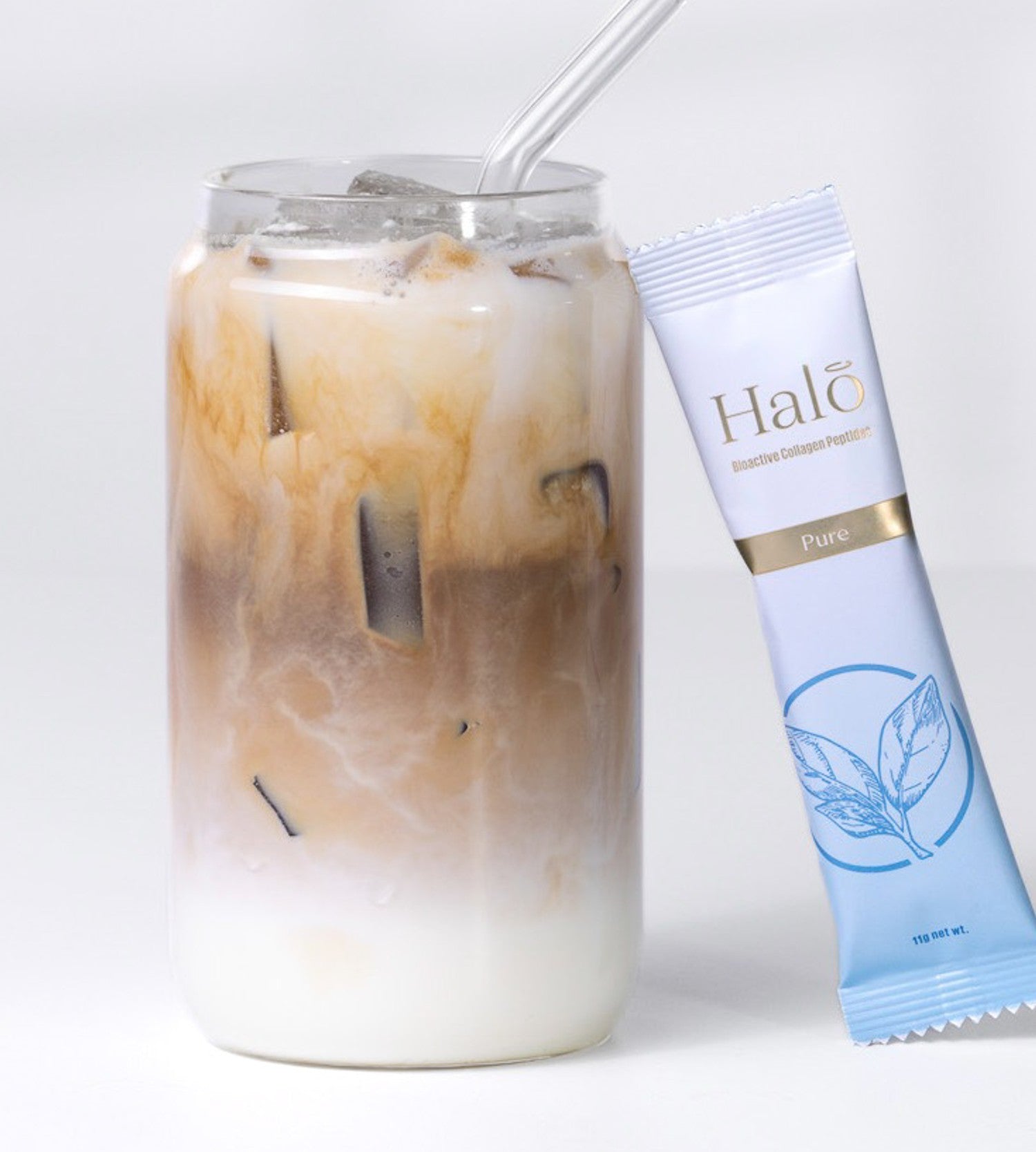 A Halo 100% Pure sachet beside an iced latte